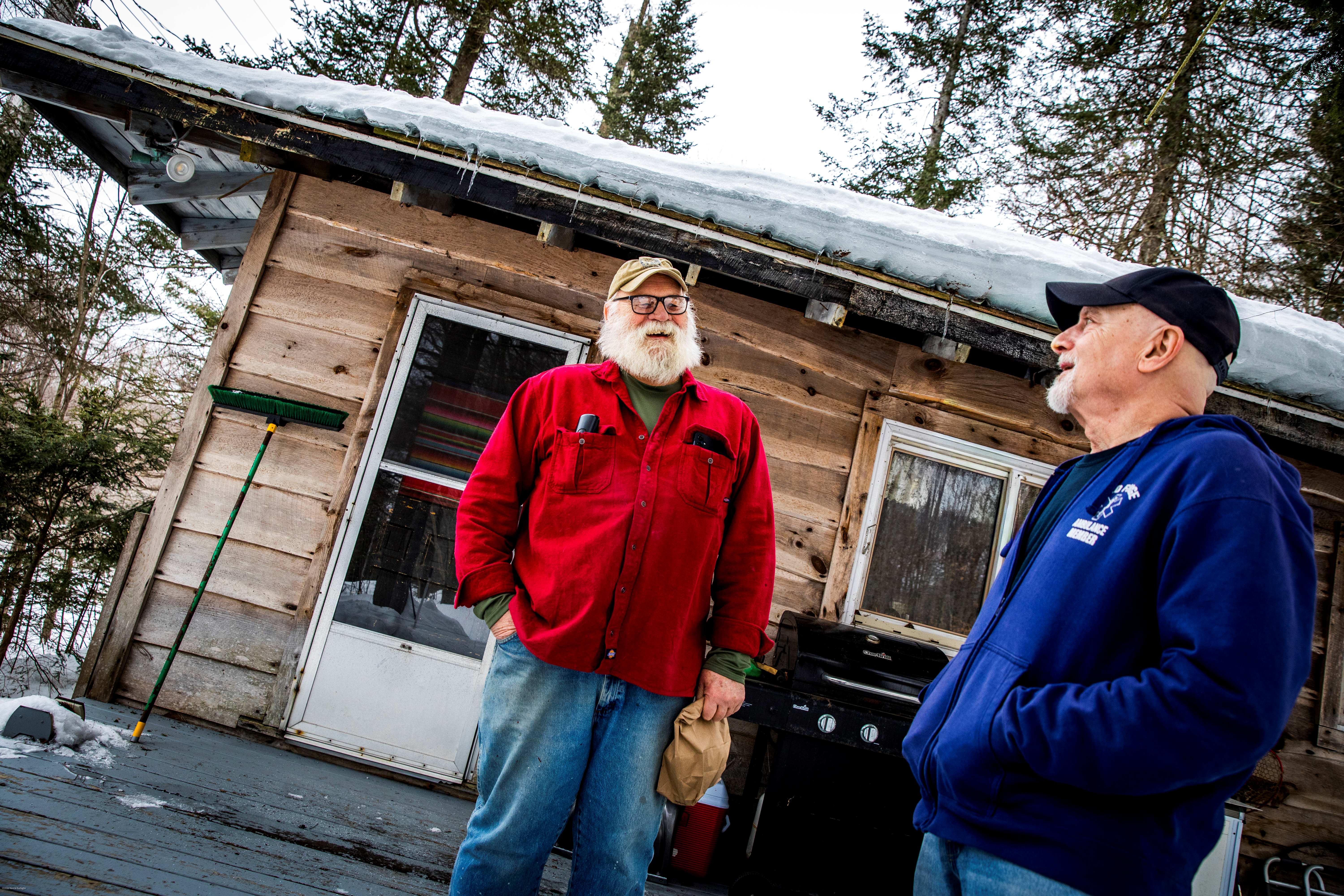 two men in front of cabin