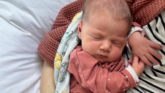 Newborn snuggling with mother
