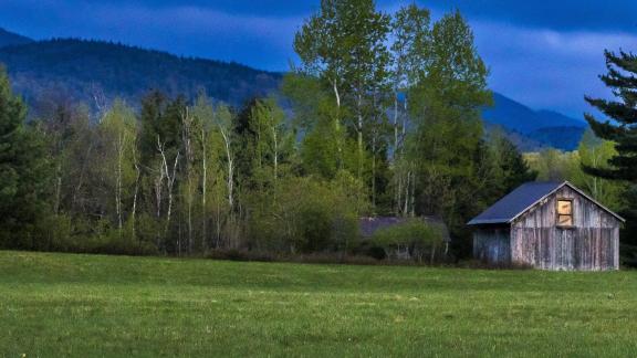 evening view of barn and field