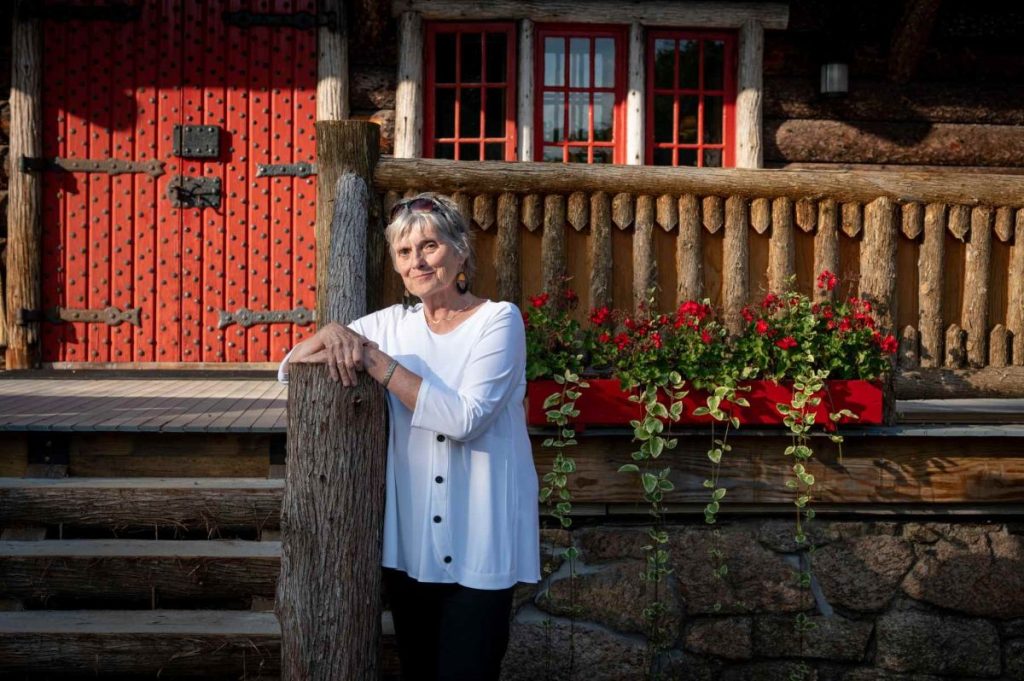 Woman stands in front of home