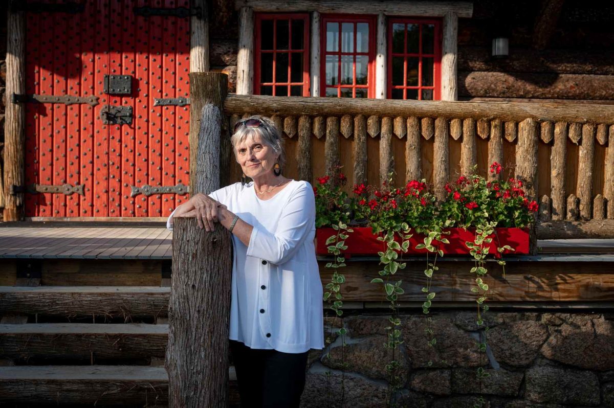Woman stands in front of home