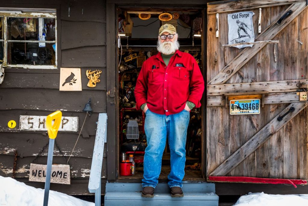 Man stands in doorway of his home