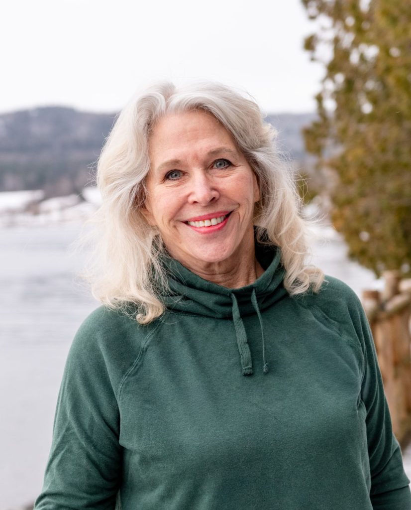 woman on balcony overlooking lake