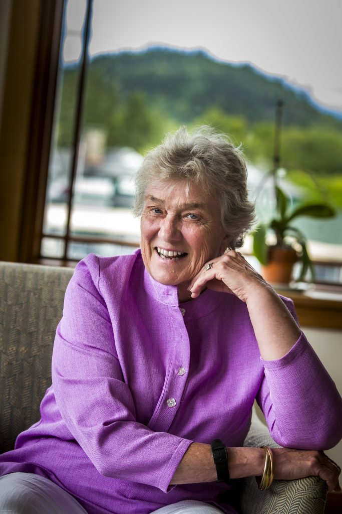 Woman smiles wearing purple