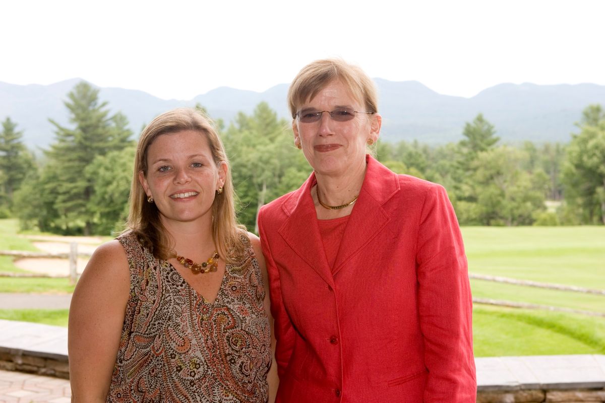 two women in front of mountain scene